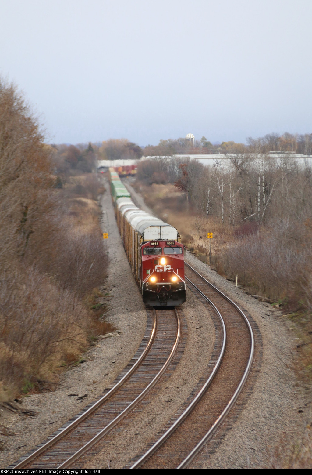 CP 8065 approaches westbound with 199 stretched out through the wetlands behind it